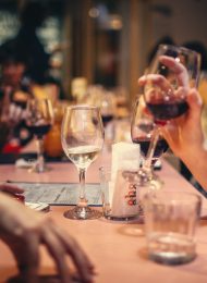 people drinking liquor and talking on dining table close up photo